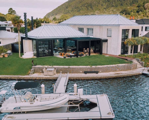 Bask louvre roofs with drop down awnings on waterside home