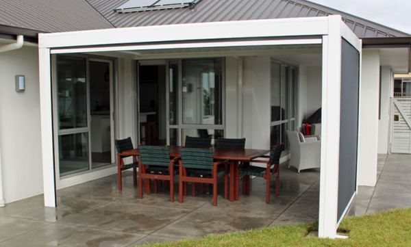 Freestanding louvre roof with drop down awnings for outdoor use at a modern home in Tauranga