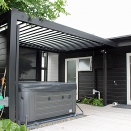 Bask louvre roof with matching slat windbreak as spa shelter on back deck